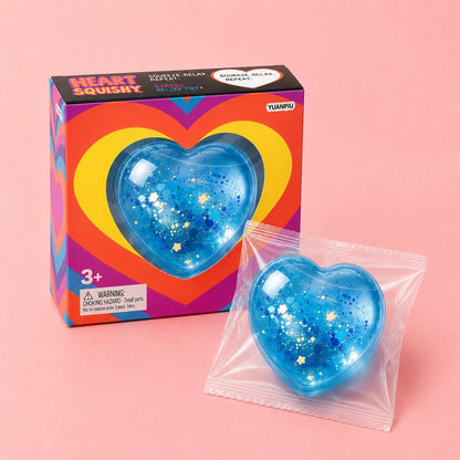 Blue glitter heart squishy sensory toy with retail packaging, a soft satisfying fidget and stress relief squeeze toy for everyday relaxation.