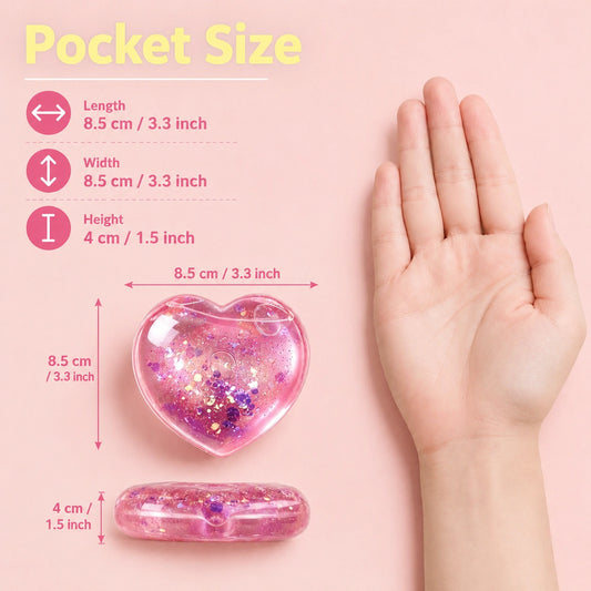 Pocket-size pink glitter heart squishy stress relief toy shown with hand for size comparison, measuring 8.5 x 8.5 x 4 cm.