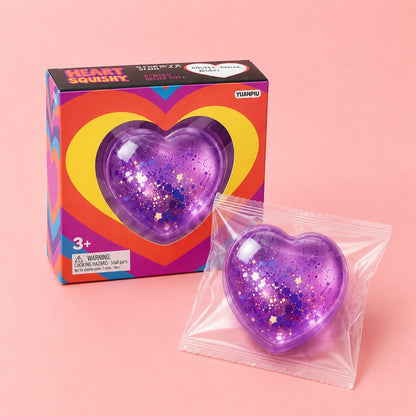 Purple glitter heart squishy stress relief toy with colorful gift packaging, a soft satisfying squeeze toy for fidgeting and relaxation.