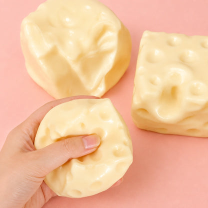 Hand squeezing a soft cheese sensory fidget toy for relaxation and stress relief
